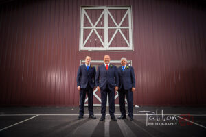 Calgary groomsmen at wedding in front of barn
